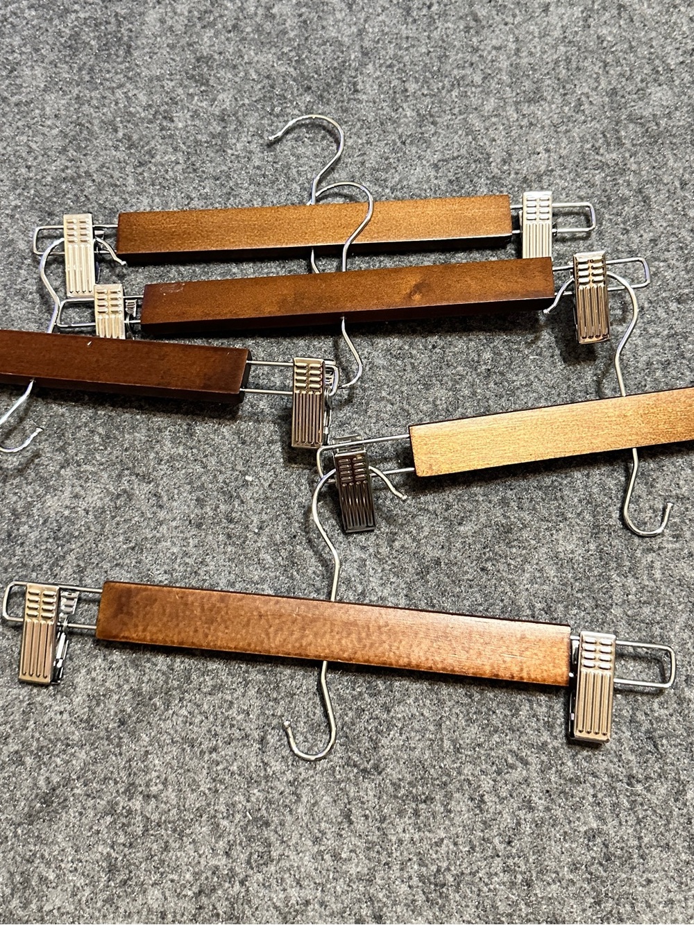Set of 5 wooden pant and skirt hangers with adjustable metal clips and swivel